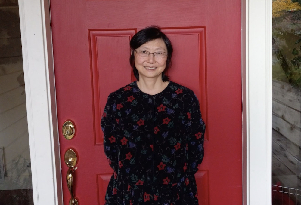Joyce standing in front of a red door